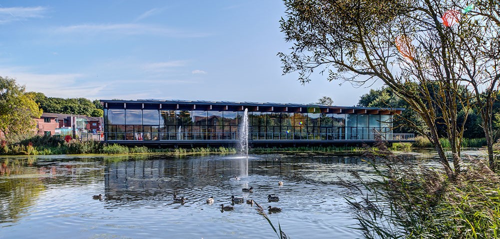 glass fronted conference centre overlooking a lake